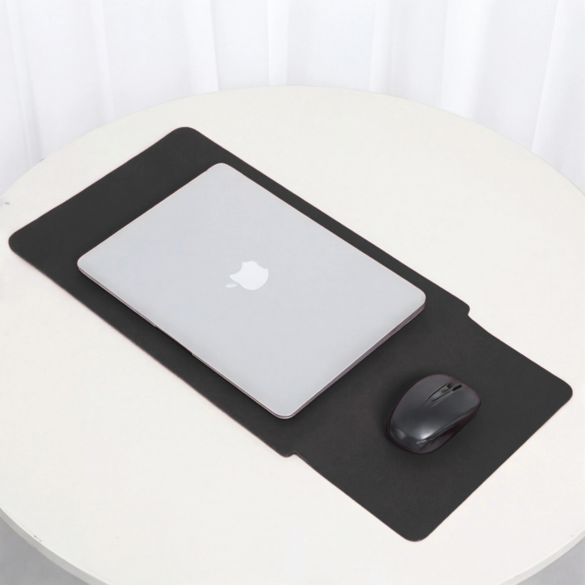 Black laptop sleeve with integrated mouse area, laptop resting on top
