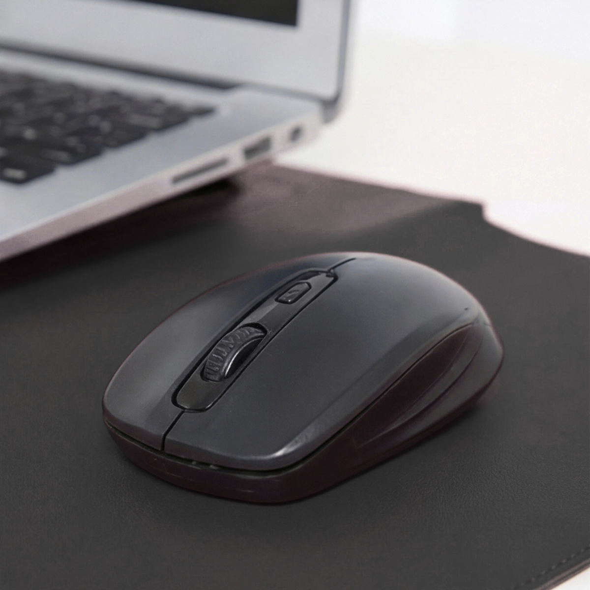 Black laptop sleeve surface with stitched edge, mouse resting on it